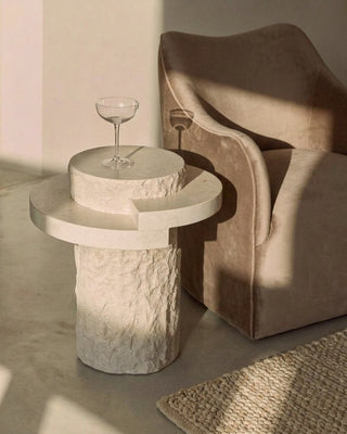 Tierra Petite side table in Spanish Beige Marble beside the Sable Lounge Chair in Mushroom Velvet, lifestyle view